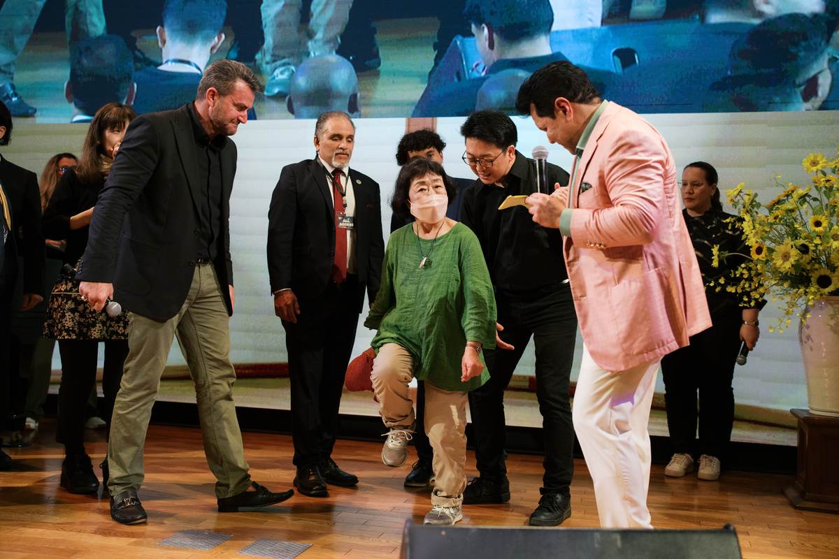 A woman walking on stage after receiving new knees